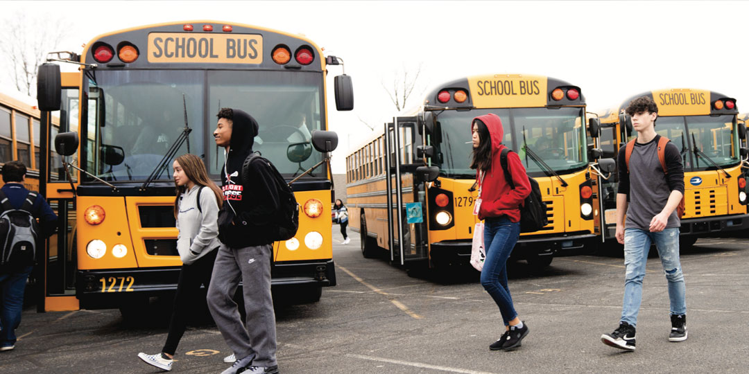 Children in school parking lot with buses Children in school parking lot with buses